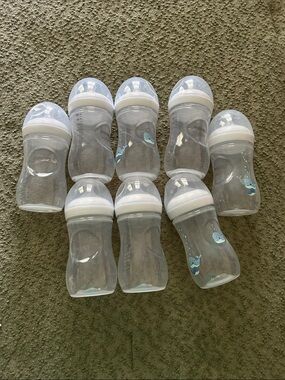 Clear Baby Bottles with White Caps and Light Blue Whale Detail on some.Brand new